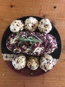 Fromage blank log with walnuts and rosemary rolled in cranberries, and rosemary plum filled truffles rolled in walnuts and cranberries