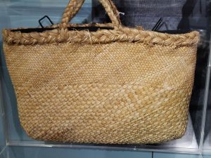 Bag woven from flax leaves. Flax became industralized after British settlement, due to the fact that it was reported to the crown as being a major useful  export. The industry saw many ups and downs and is virtually non-existent now