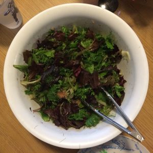 Bowl of salad with tongs