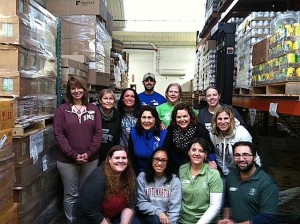 Evergreen, SPSCC, and Saint Martin's staff take a break for a group picture while working at the Thurston County Food Bank.