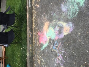 An explosion of colored chalk on a city sidewalk.