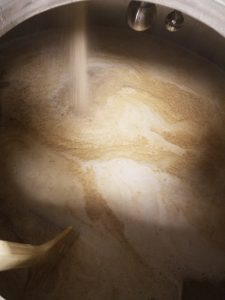 Grain being added to the mash tun.